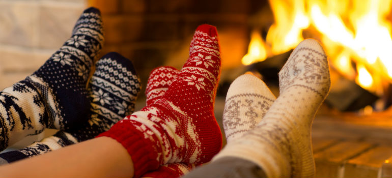 Three pairs of feet in front of the fireplace